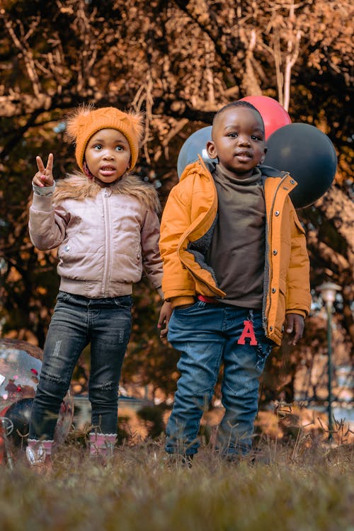 Photo of Children Wearing Jackets at a Park