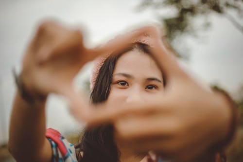 A Woman Covering Eyes on her Hands