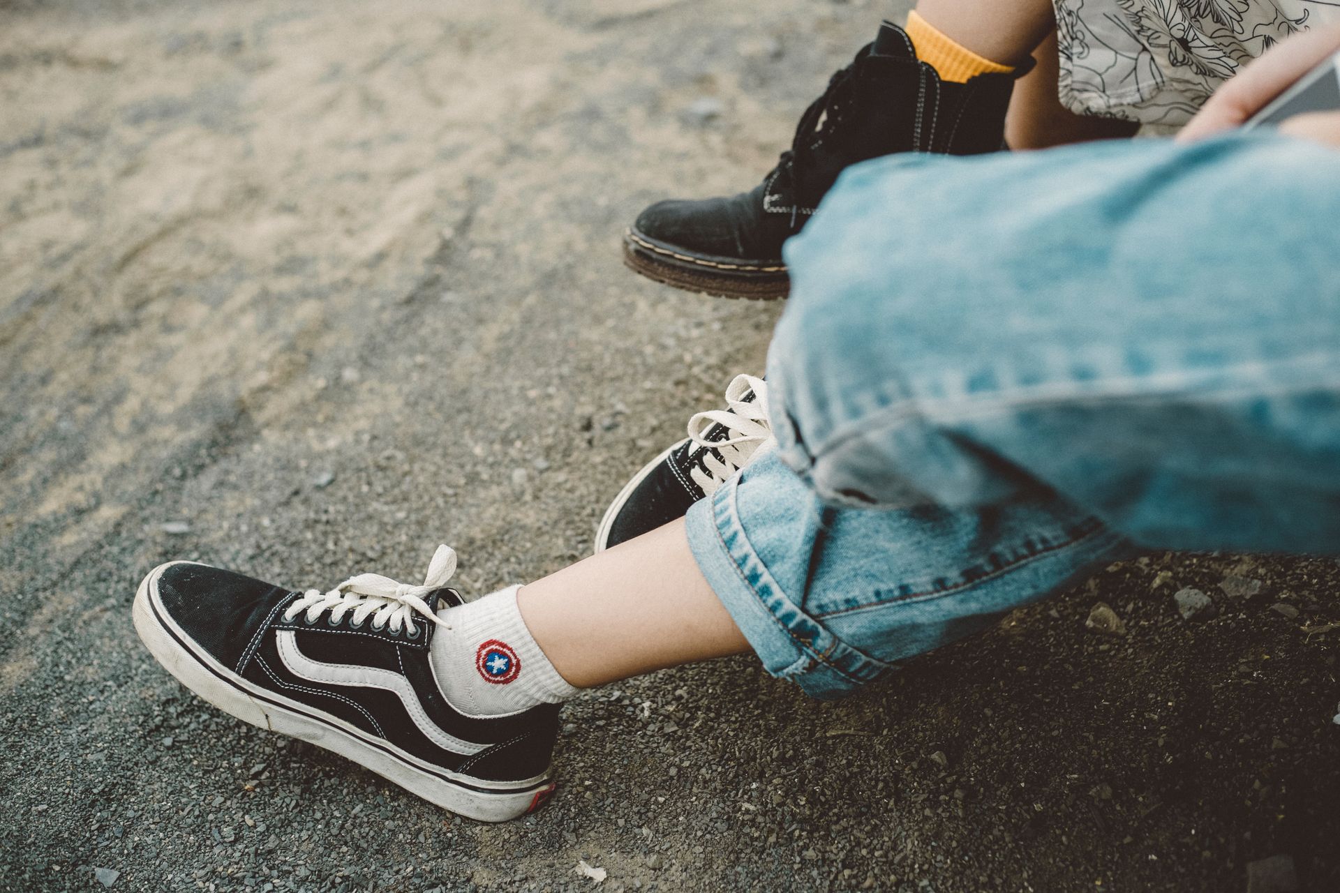 Person Wearing Denim Pants with Classic Vans Sneakers