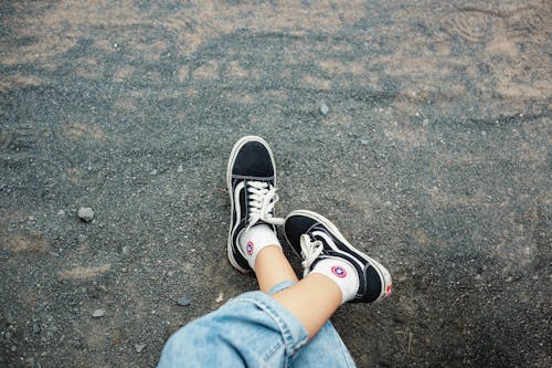 Free Person Wearing Black Sneakers Stock Photo