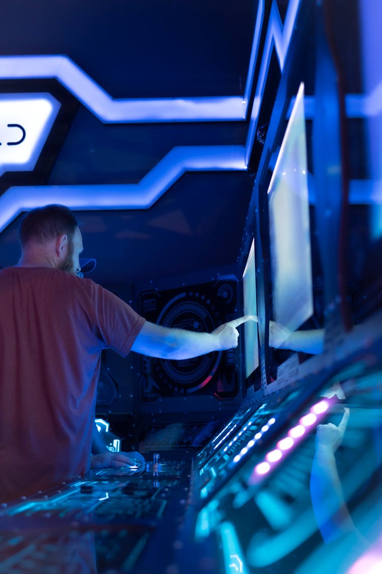 Man Sitting In A Futuristic Studio With Modern Equipment 