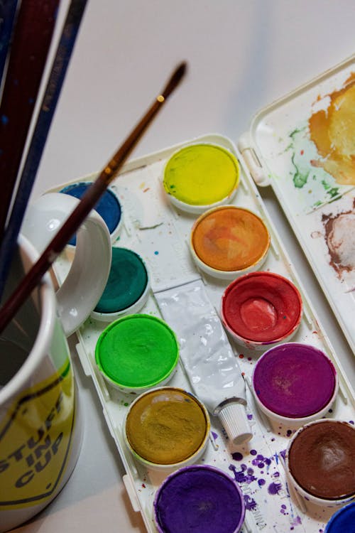 Color Palette beside a Cup of Paint Brushes