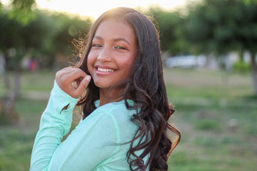 Smiling Woman in Green Long Sleeve Shirt