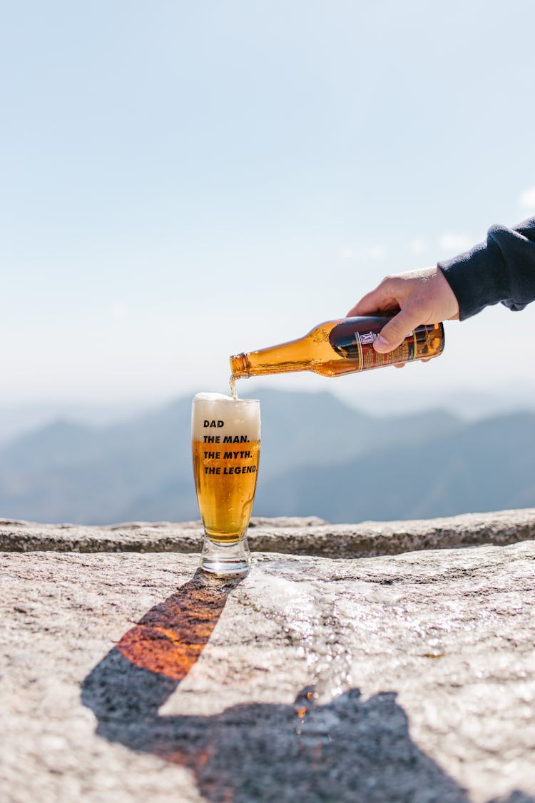 Person Pouring Beer In A Glass