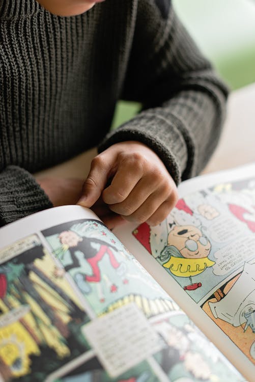 Free Person Reading a Comic Book Stock Photo