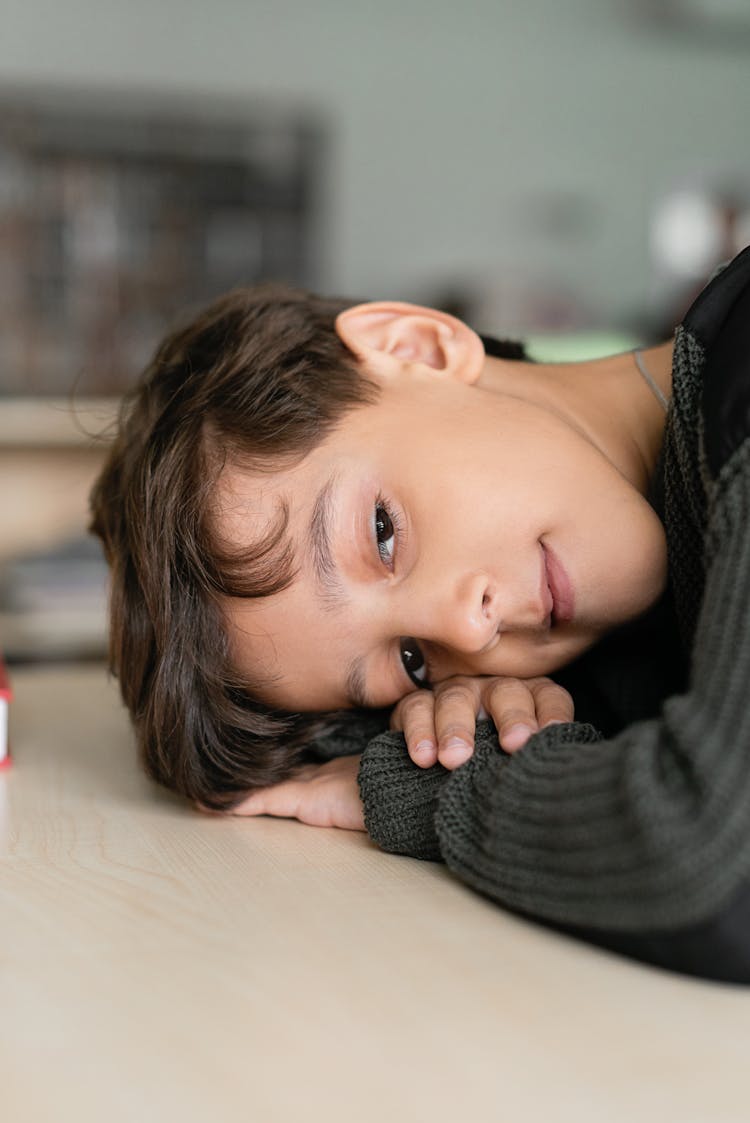 Boy Leaning On His Table