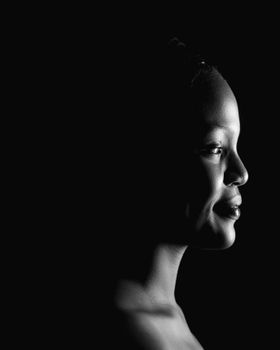 Artistic black and white side profile portrait of a woman in soft lighting.. artistic, black, white
