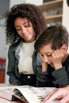 A child reading a book with a supportive teacher in a modern classroom environment.