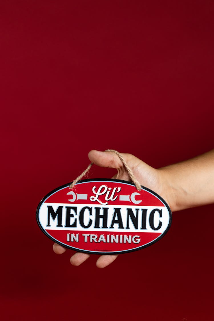 Person Holding A Red And White Signage