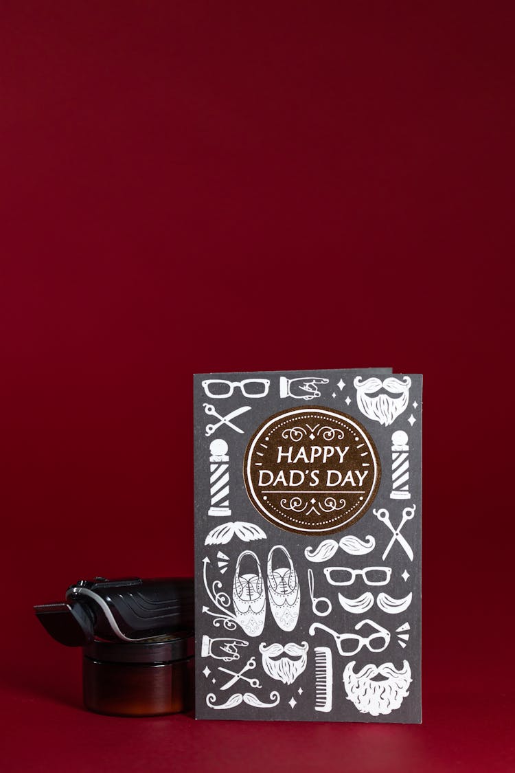 Close-Up Shot Of A Happy Father's Day Card On A Red Surface