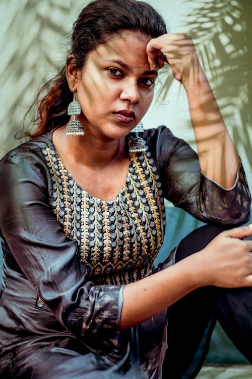 Woman in Gray Blouse with Dangling Earrings