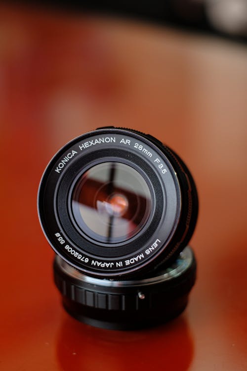 Free Black Camera Lens on Orange Surface Stock Photo