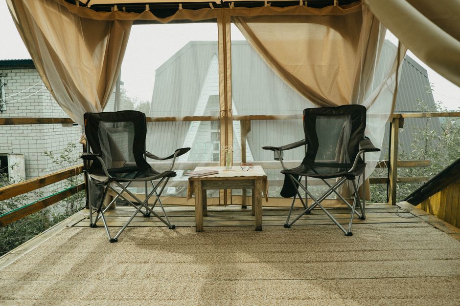 Inviting patio deck with folding chairs and wooden table, ideal for relaxing outdoors.