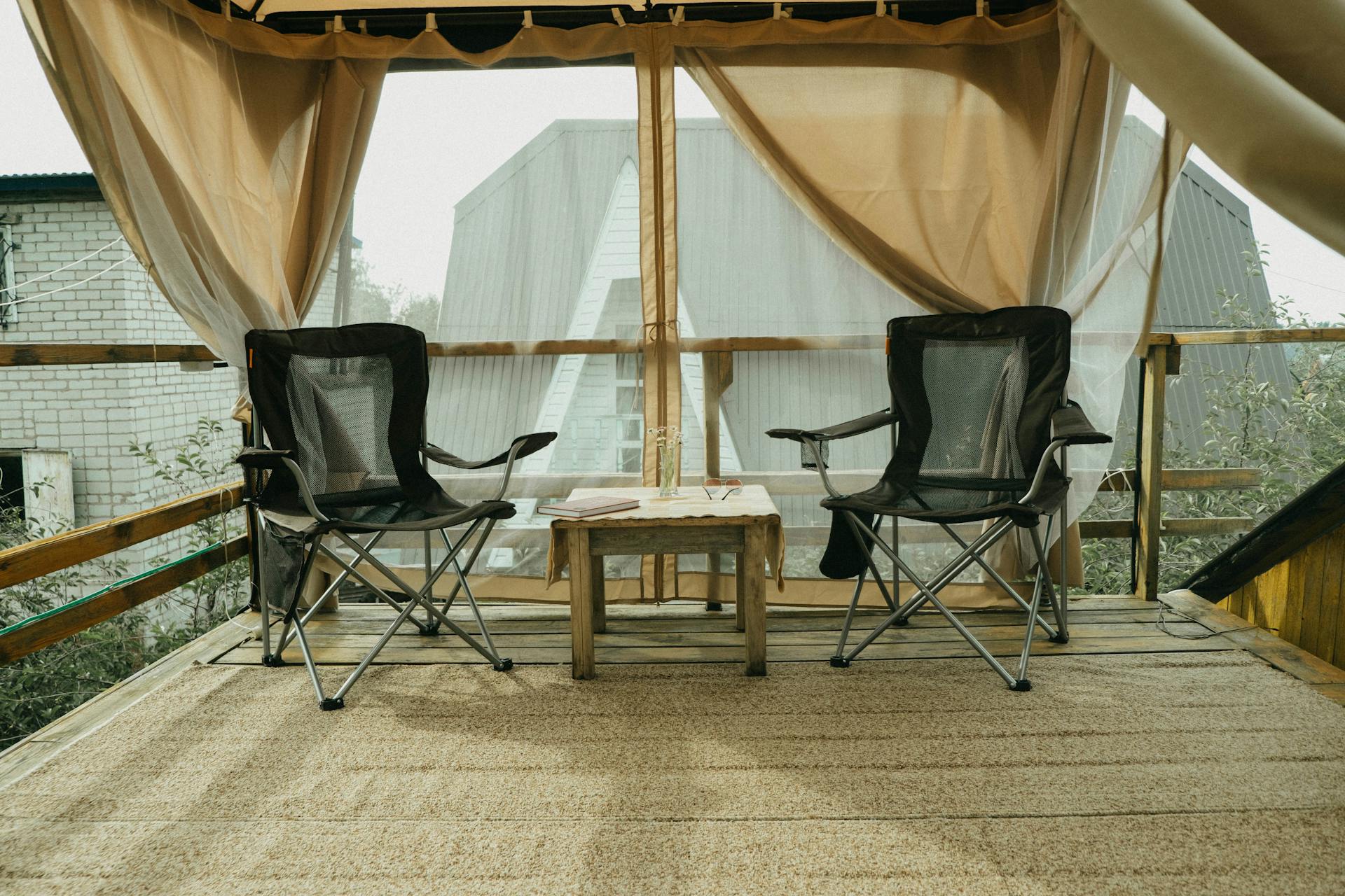 Inviting patio deck with folding chairs and wooden table, ideal for relaxing outdoors.