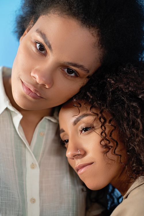 Free Intimate portrait of a couple with curly hair, showcasing love and togetherness. Stock Photo