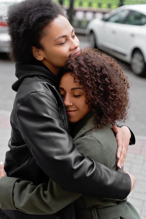Free Heartwarming outdoor embrace between two women celebrating love and connection. Stock Photo