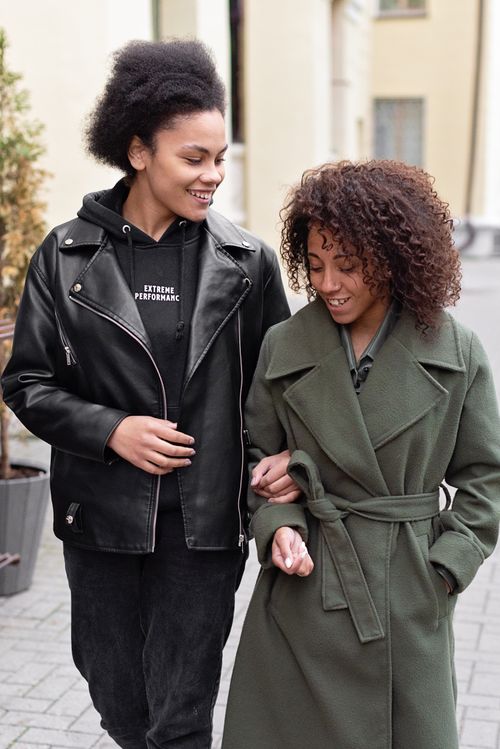 Free Smiling lesbian couple enjoying a walk outdoors, embracing love and happiness. Stock Photo
