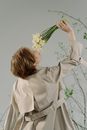 Woman in White Long Sleeve Shirt Holding Bouquet of Flowers