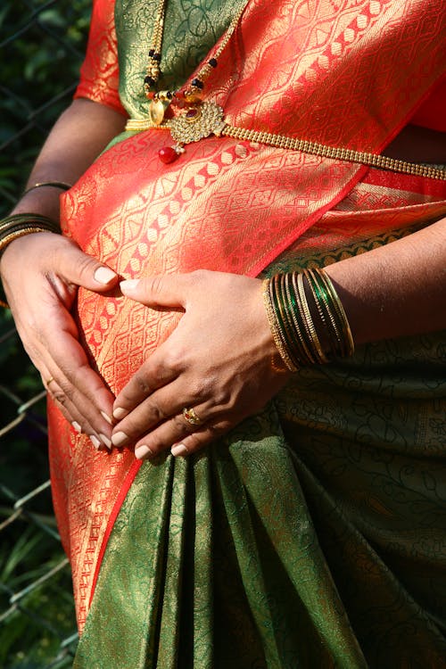 Free A Pregnant Woman in Green and Red Sari Stock Photo