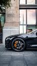 Black Car Parked Near Gray Concrete Wall