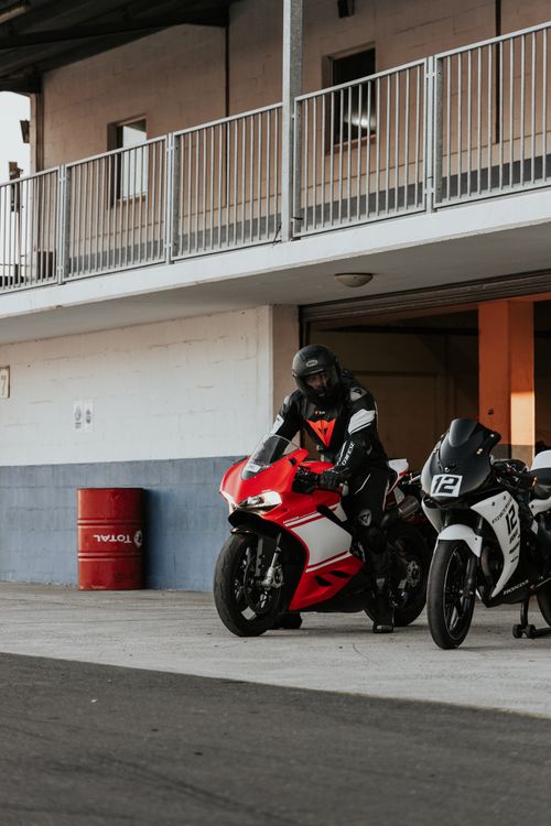 Free Motorcyclist in gear with red sports bike on a race track in Cape Town. Stock Photo