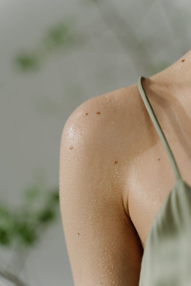 Woman In Green Spaghetti Strap Top With Sweat On Body