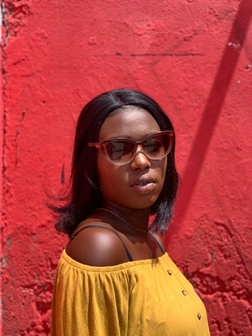 A Woman in Yellow Top Wearing a Sunglasses