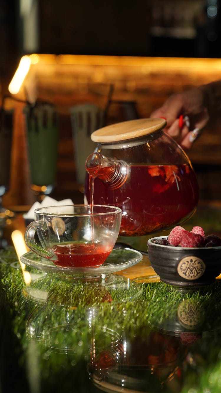 Clear Glass Jar With Fruit Juice Being Poured Into A Cup