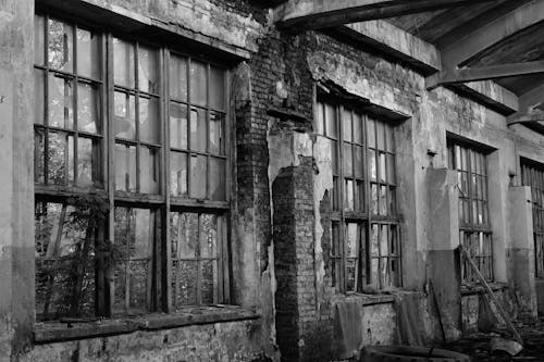 Free Grayscale Photography of a Broken Brick Wall with Windows Stock Photo