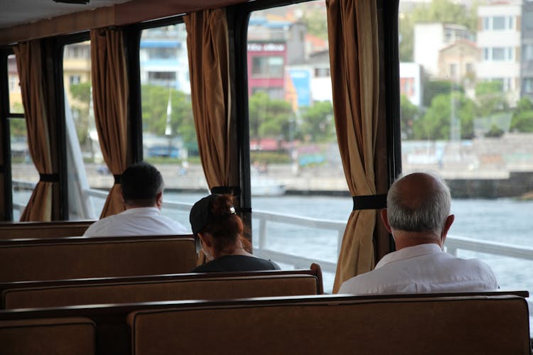 People Riding On A Bus Observing Social Distancing