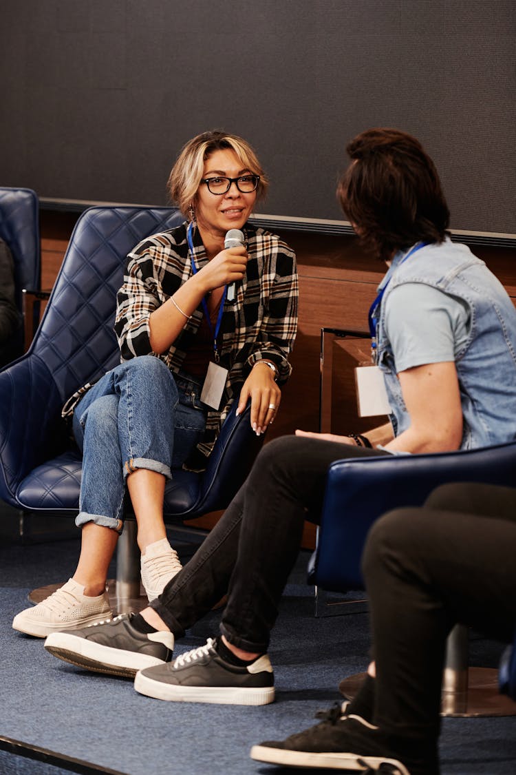 A Woman With A Microphone Talking With A Man