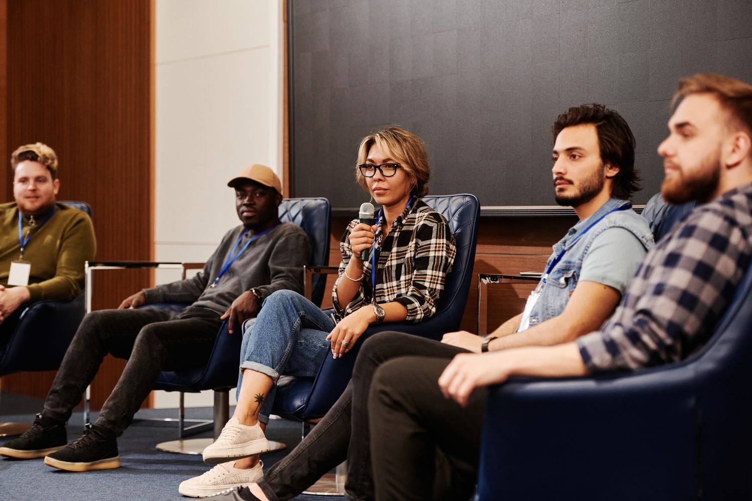 Panelists speaking during a conference