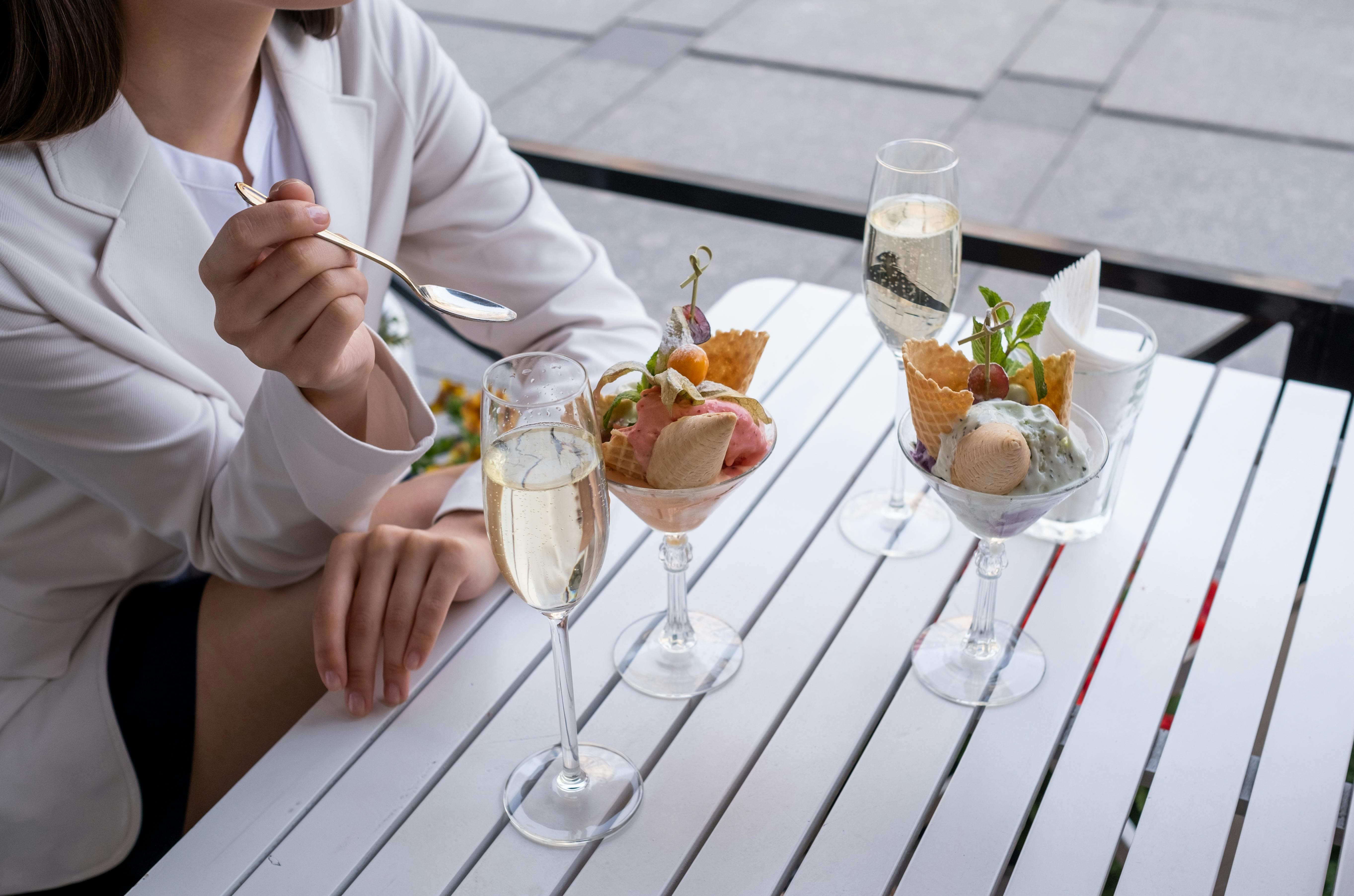Stylish scene with ice cream and champagne on a sunny patio. Perfect for indulgence and lifestyle themes.