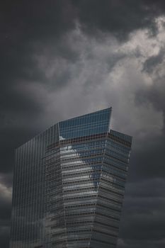 Elegant skyscraper in Milan, Italy with a moody, overcast backdrop.