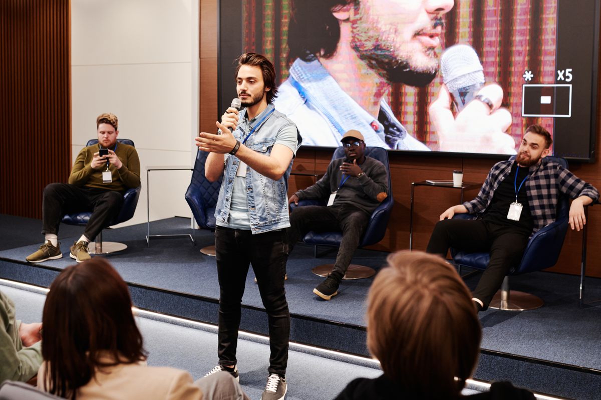 Speaker addressing an audience at a business conference, illustrating thought leadership