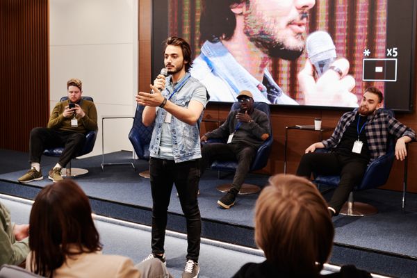Speaker addressing an audience at a business conference, illustrating thought leadership