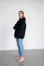 Woman in Black Hoodie and Denim Jeans