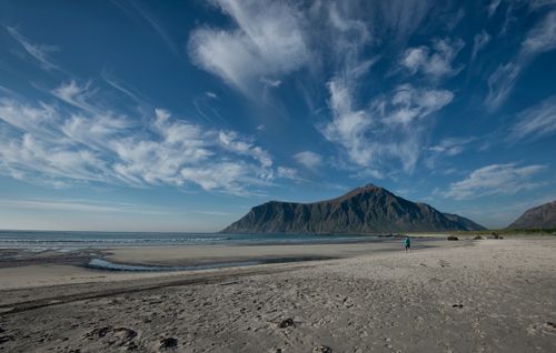 Free A scenic view of a beach with mountains in Nordland, Norway, under a blue sky. Stock Photo