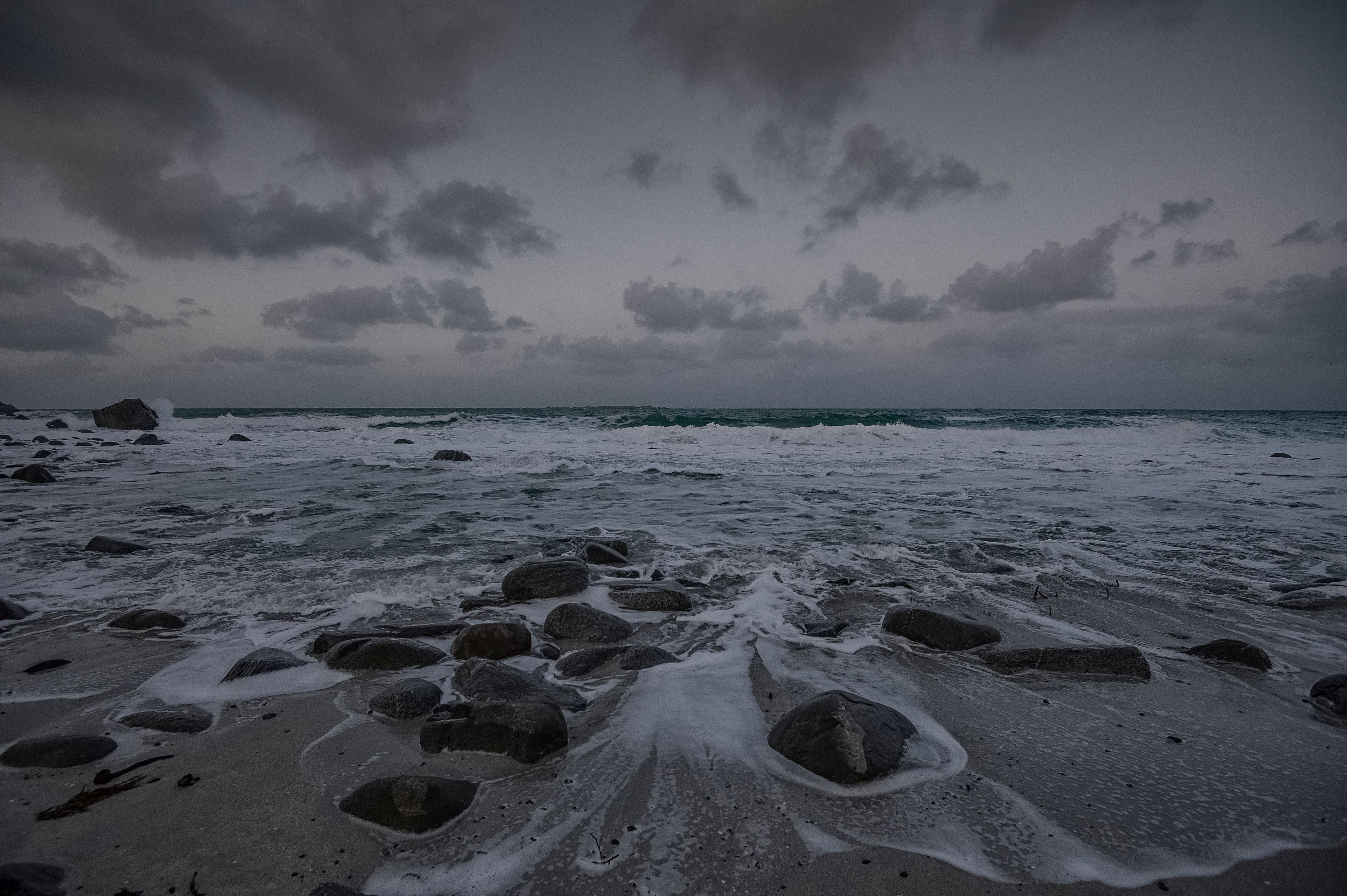 Ocean Waves Crashing on Shore Under Cloudy Sky · Free Stock Photo