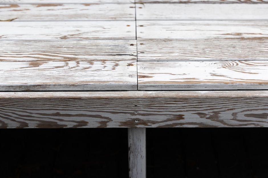 Detailed view of aged wooden planks, showing texture and screws for rustic design ideas.