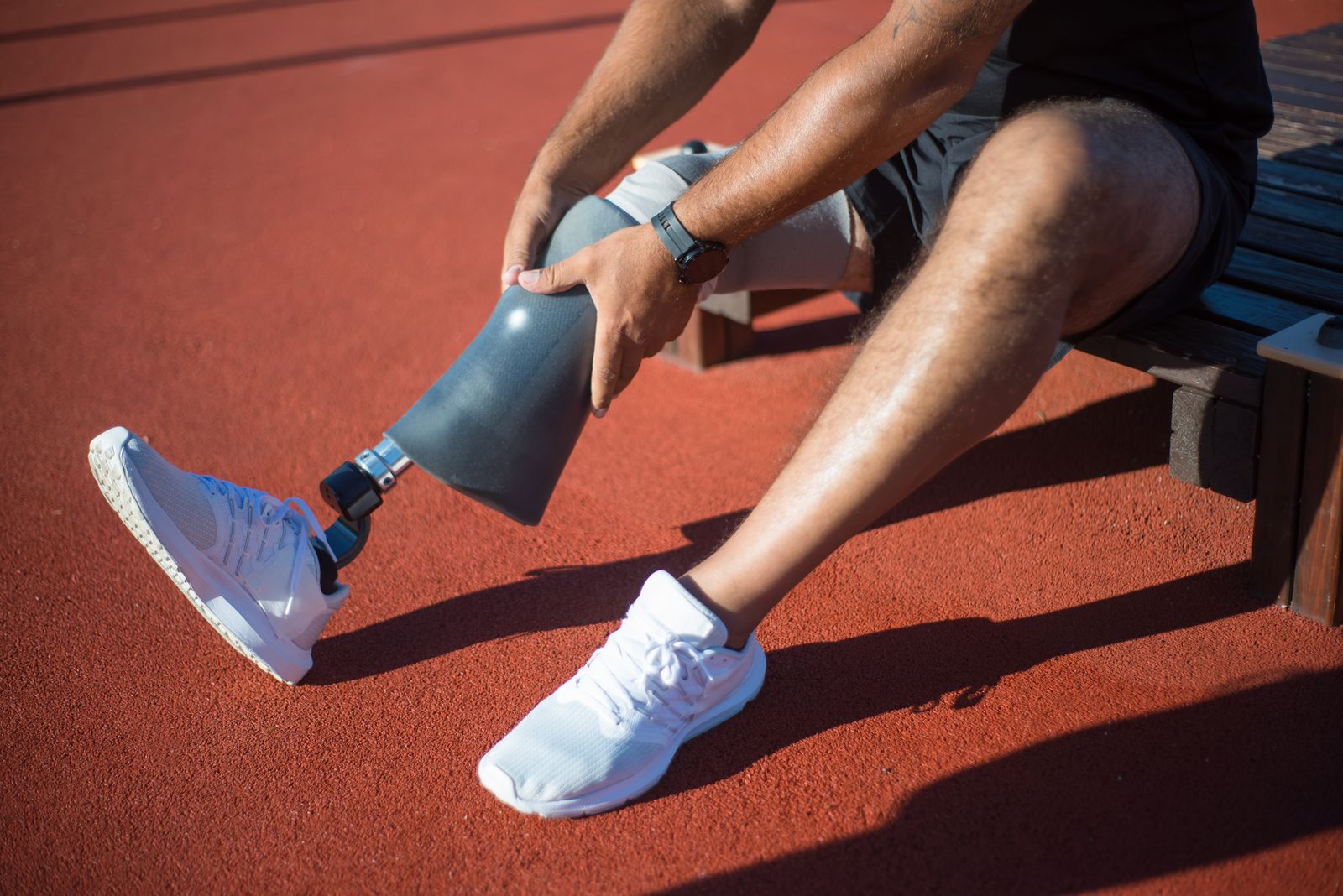 Runner adjusting a knee support outdoors before activity