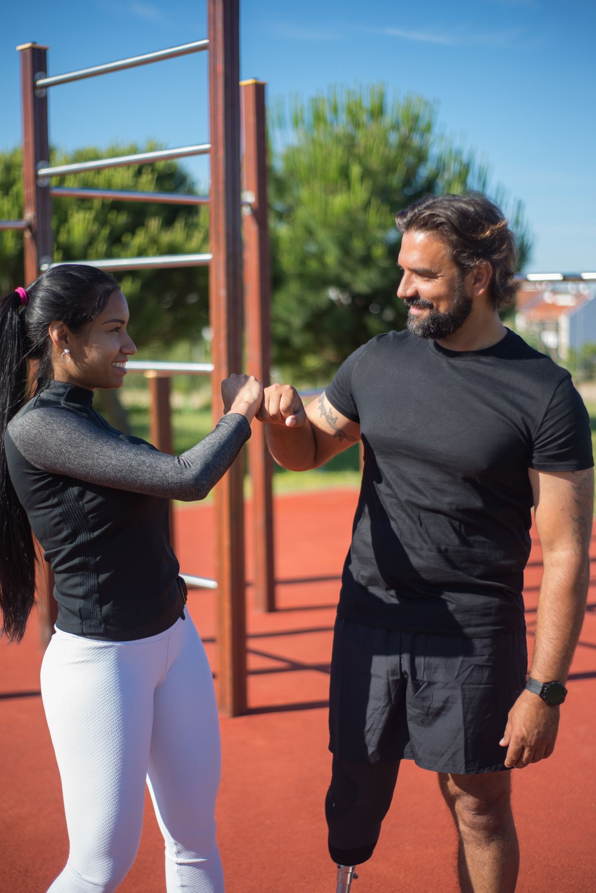 Two athletes marking the end of a session with a fist bump — photo by Kampus Production on Pexels