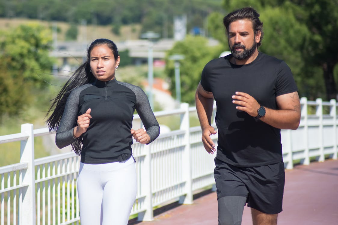 Man and Woman Jogging Outdoors
