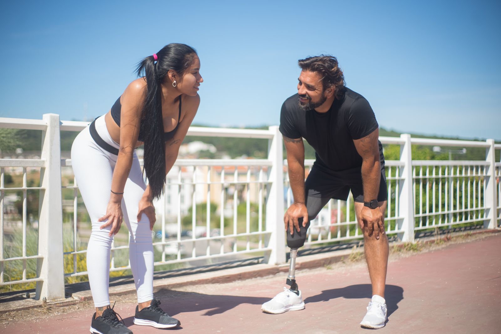 Runner adjusting a knee brace outdoors before activity