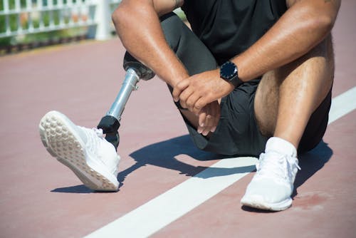Free A Man with Prosthetic Leg Sitting on the Ground Stock Photo
