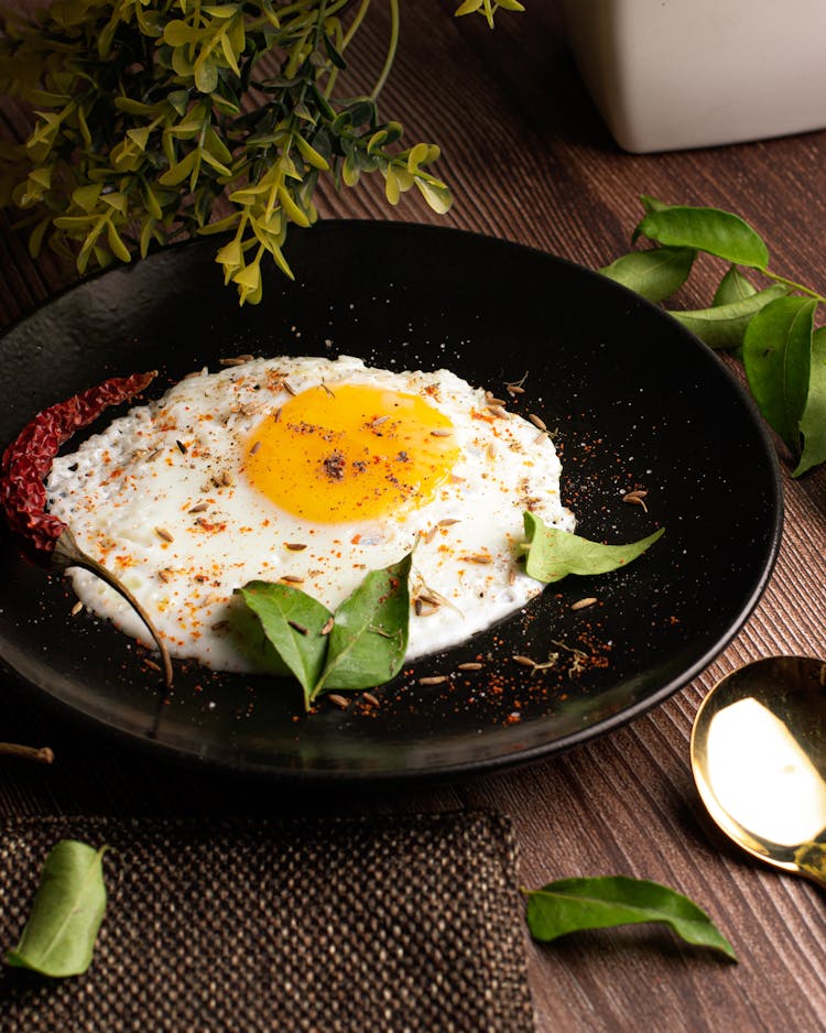 Sunny Side Up Egg On Black Ceramic Plate