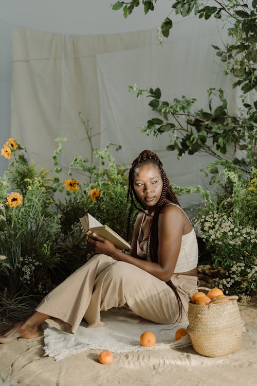 Woman Holding Book While Looking Over Shoulder