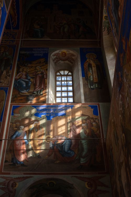 Free Dimly lit church interior showcasing stunning religious iconography and arched windows. Stock Photo