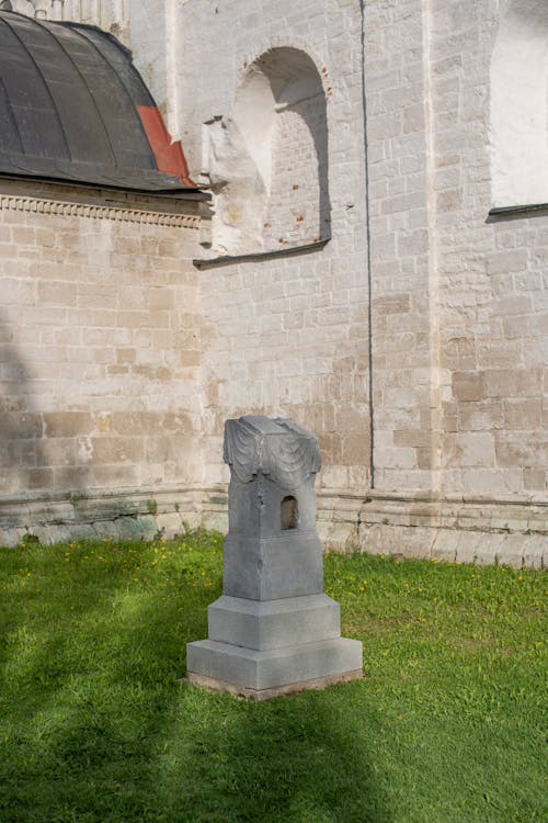 Broken Sculpture beside Church