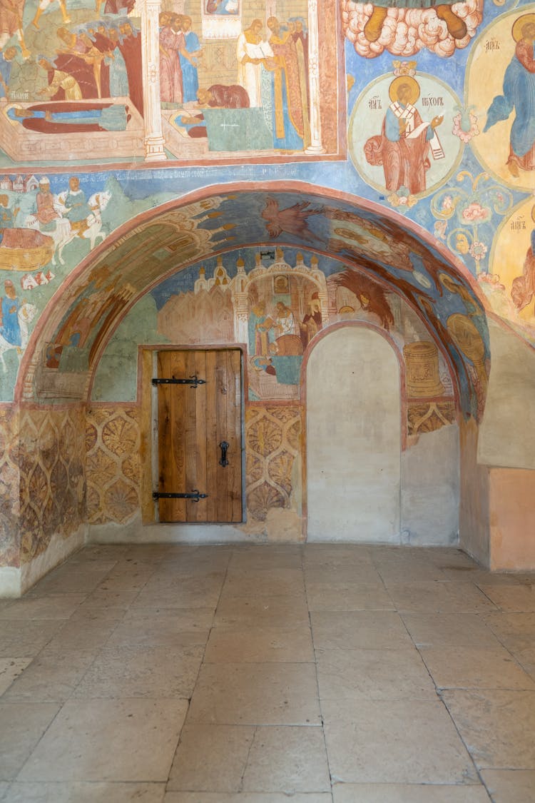 Faded Frescoes On Wall Of Church